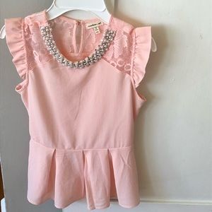 Pink peplum top w/ a pearl embellished neckline.